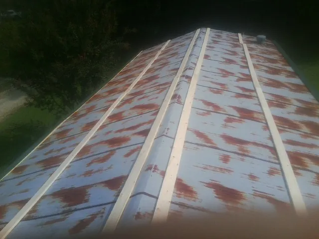 Rusted metal roof panels with new wood purlins before replacement — Storm Damage Roof Repair in Lone Oak by Roofing Brothers